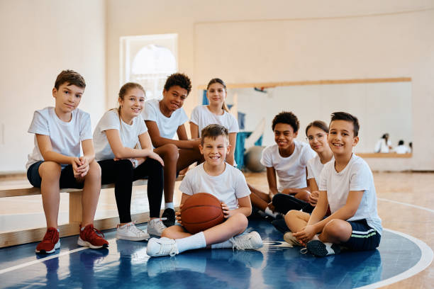 istock Portrait of happy students during PE class at elementary school looking at camera. 1480546397