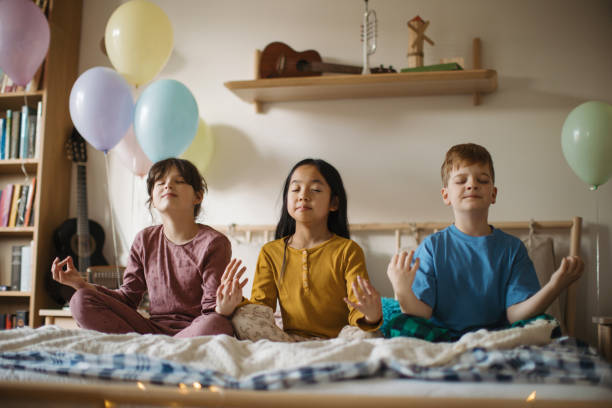 istock Three happy friends sitting on a bed and mediating. 1480547116