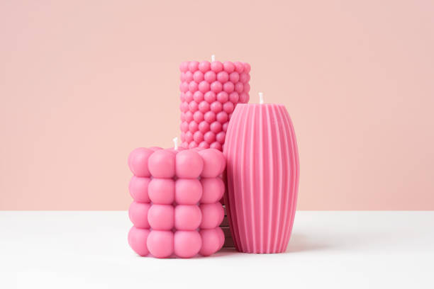 istock Handmade olive wax different forms pink color candle on a duotone pastel pink and white background. Sustainability vegan candle, natural materials. Minimalistic, modern photo. Copy space. Horizontal 1480547227