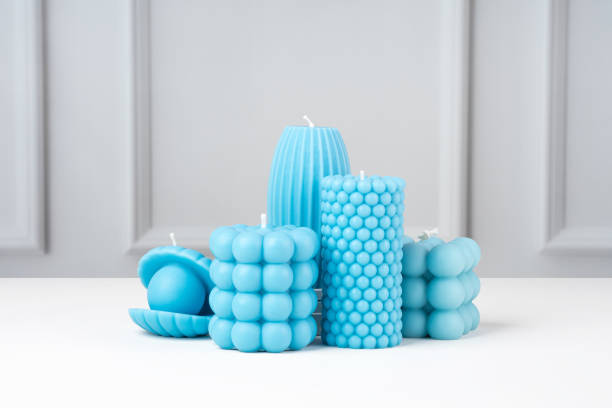 istock Handmade olive wax different forms blue color candle on a on the white table at home. Sustainability vegan candle, natural materials. Minimalistic, modern photo. Copy space. Horizontal 1480547232