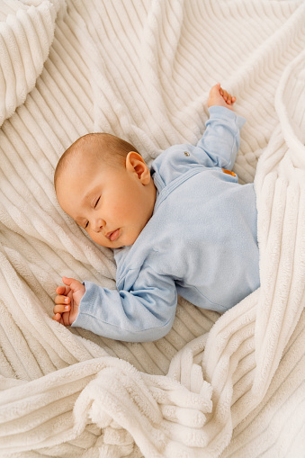 Above shot of a baby sleeping on a bed