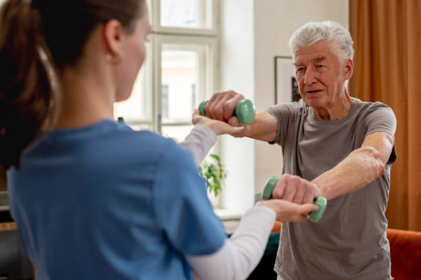 istock Young nurse doing exercise with senior man. 1480547483