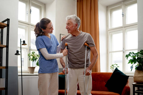 istock Young nurse helping senior man with walking. 1480547531