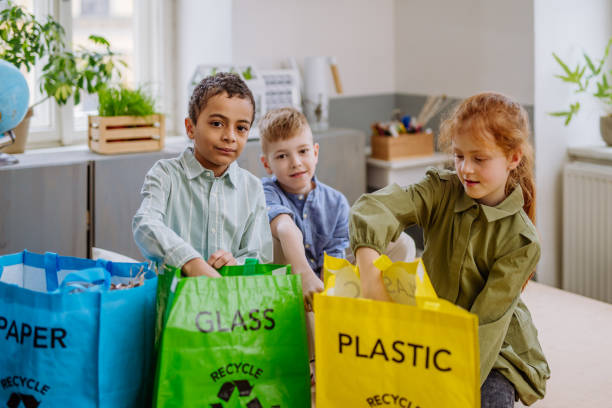 istock Children separating rubish in to three bins. 1480549572