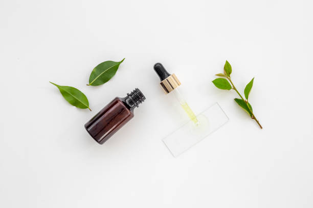 istock Tea tree essential oil in dropper bottle. Herbs cosmetic background 1480551279
