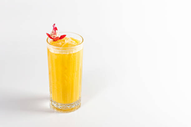 istock A yellow cocktail in a deep glass is decorated with a flower and ice. 1480554840
