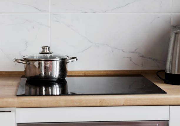 istock Black ceramic induction stove with metal pot 1480555023