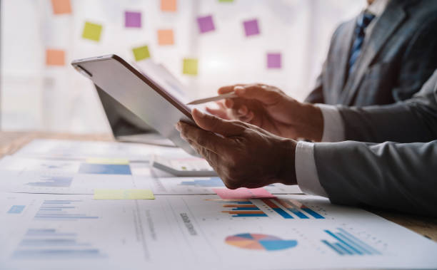 istock Business corporate team brainstorming, planning strategy having a discussion Analysis investment researching with chart at office desk documents in office. 1480558197