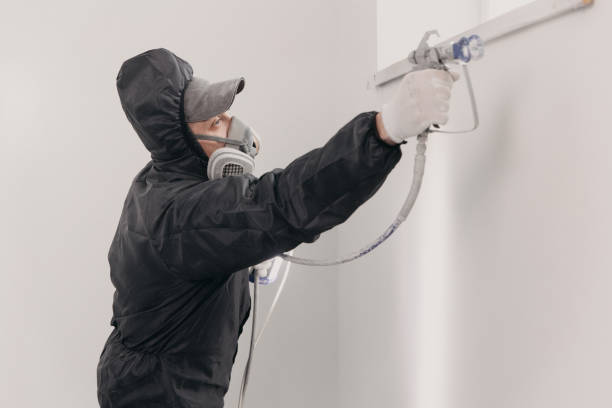 istock Decorator painting wall with spray indoors, space for text 1480559451