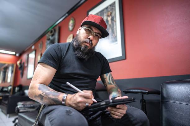 istock Portrait of a mid adult working using a digital tablet at tattoo studio 1480560258