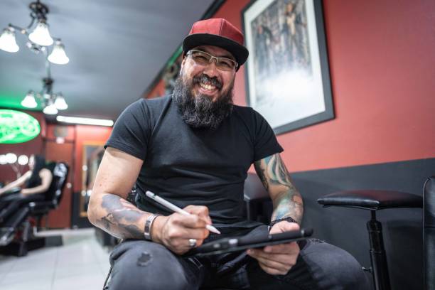 istock Portrait of a mid adult working using a digital tablet at tattoo studio 1480560259