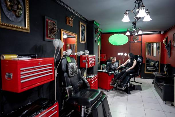 istock Tattoo artist doing a tattoo on a customer at tattoo studio 1480560401