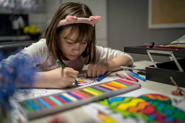 girl painting large Easter egg on paper