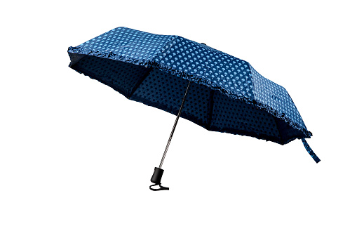 Opened patterned blue umbrella isolated on white background, cut out, clipping path, studio shot