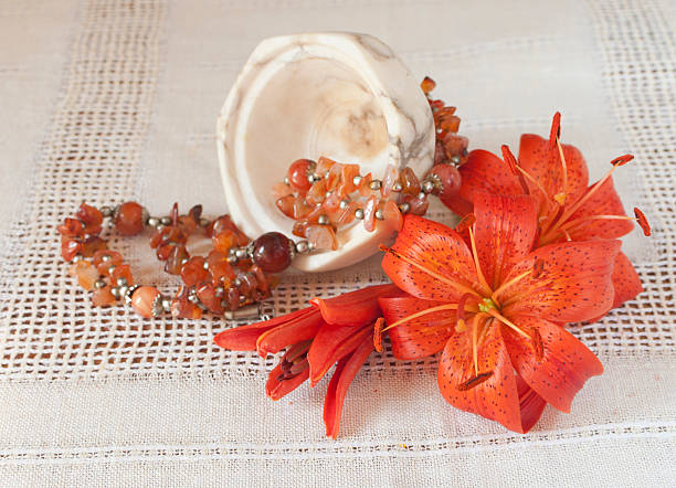 orange flowers and beads orange tiger lily flowers and vintage beads at table red tiger lily stock pictures, royalty-free photos & images