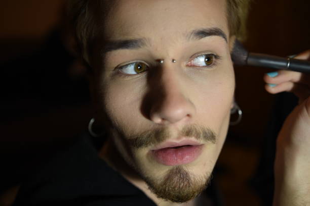 Drag queen person applying makeup in dressing room