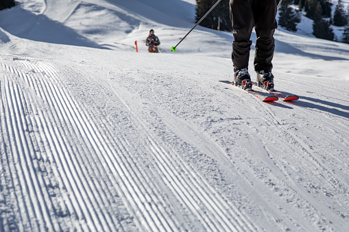 skiers on freshly groomed slopes
