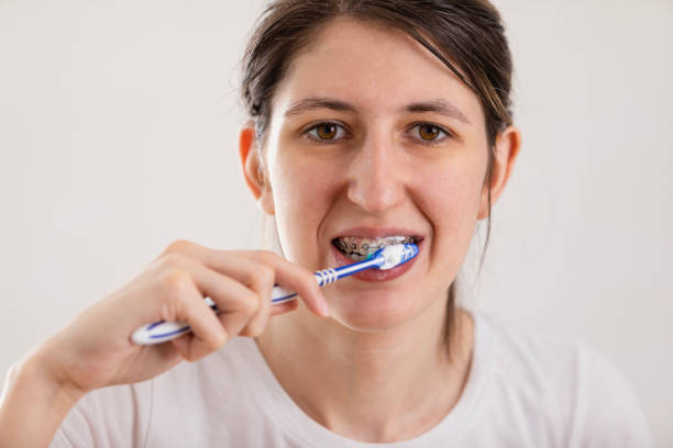 istock Young woman is brushing her teeth in a bathroom 1480566847