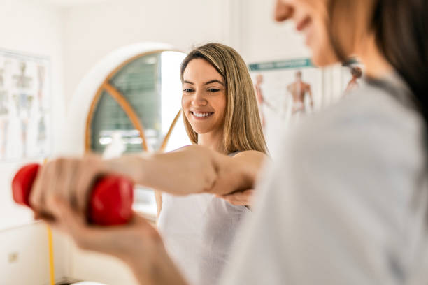 istock Young woman with physical therapist 1480568362