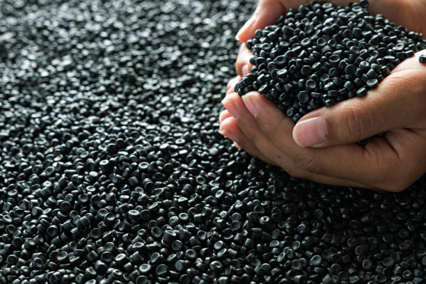 Small pieces of crushed plastic. Crushed bottle caps for recycling. Plastic waste that will be mixed with plastic vergin. Concept reducing plastic.