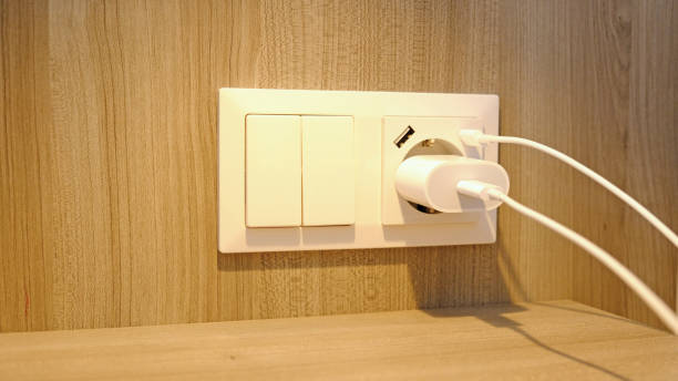 istock Electrical power socket, usb socket, light switch on the wood panel in the interior of the hotel. For convenience, the mobile charger or smartphone in the concept of modern life. Selective focus. 1480570233