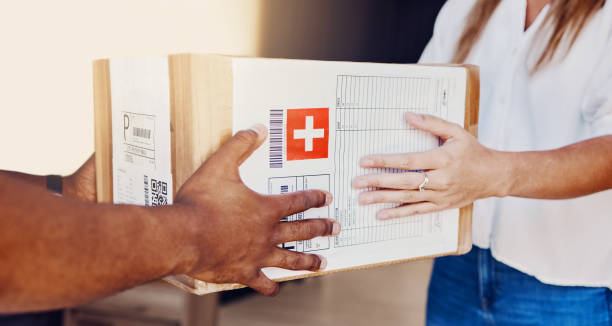 istock Delivery, box and hands of courier man with a customer for ecommerce, orders and online shopping package. Hand, person and guy giving woman parcel, goods or retail product at the door of her home 1480570351