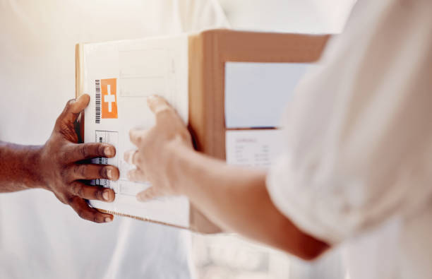 istock Box, delivery and hands of courier man with a customer for ecommerce, orders and online shopping package. Hand, person and guy giving woman parcel, goods or retail product at the door of her home 1480570353