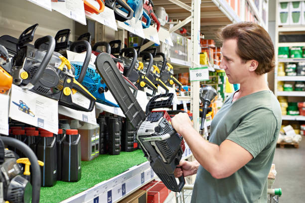 istock Man chooses gasoline saw 1480571323