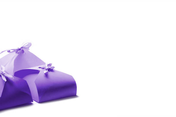 Small purple boxes for gifts on a white background.Place for text. Template for a postcard. Horizontal frame.