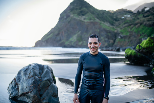 Portrait of smiling surfer on the beach.