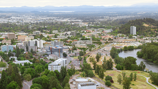Aerial view of modern buildings near river in city, Eugene, Oregon, USA.