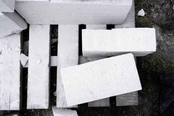 Aerated concrete brick is cut into different sizes. Universal building material gas block. White porous building block