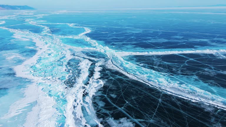 drone aerial view of cracks surface of the frozen lake of Baikal lake in winter season,Aerial view from the air. Winter. Ice Lake Baikal Russia