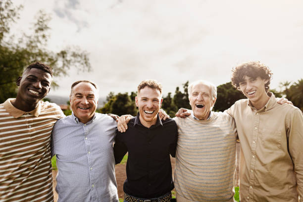 istock Happy multigenerational group of men with different ages and ethnicities having fun smiling in front of camera at park 1480574600