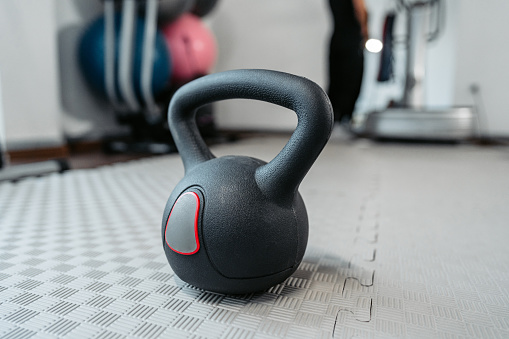 Close-up of a kettlebell on the gym floor.