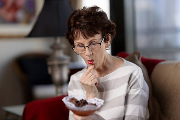 istock Senior woman with excited expression about to eat chocolates 1480580499