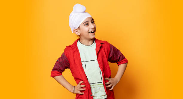 istock indian kid standing and smiling with hand on waist 1480582291