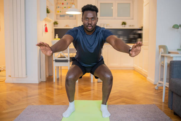 istock Man at home keeping fit by exercising 1480587804