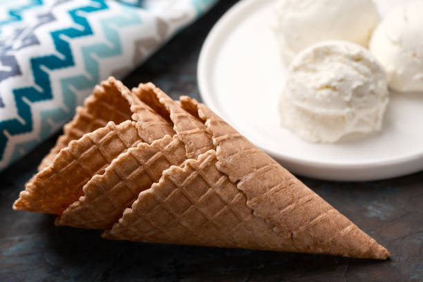istock Ice cream balls, scoops and waffle cones on dark background. Advertising space. 1480588031