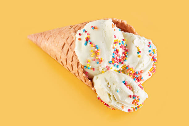 istock ice cream balls in a Waffle Cone on a Blue Background. Vanilla ice cream in a waffle cone. 1480588217
