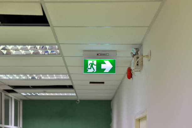 istock Green emergency exit sign showing the way to escape. Fire exit in the building. 1480589606