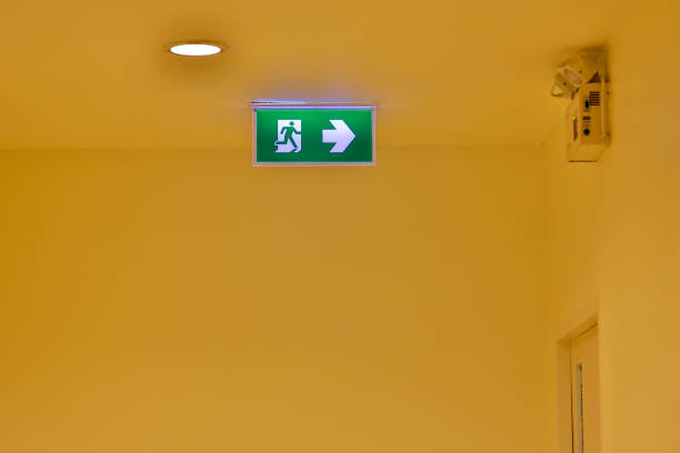 istock Green emergency exit sign showing the way to escape. Fire exit in the building. 1480589672