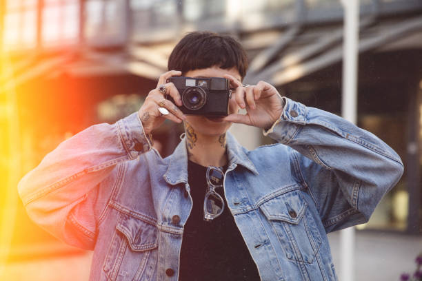 Woman uses analog camera film point and shoot