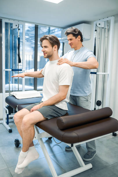 istock Male physical therapist working with a patient and looking invloved 1480590168