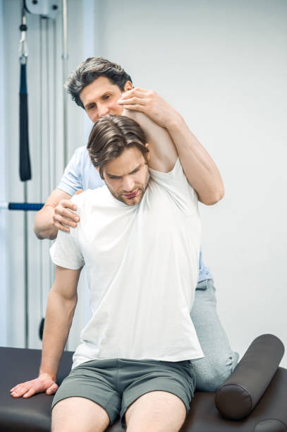istock Physical therapist working with patients neck 1480590204