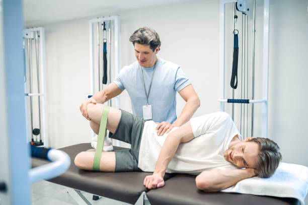 istock Patient lying on a couch and exercising with a resistance band 1480590267