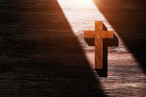 Religious cross on wooden background