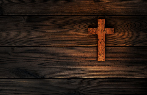 Religious cross on wooden background