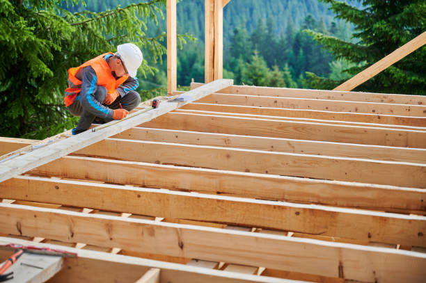 istock Carpenter measures distance with tape measure while building wooden frame house. 1480592351