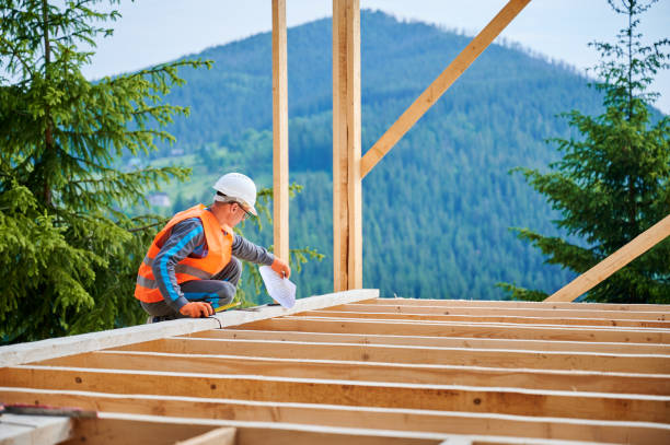 istock Carpenter measures distance with tape measure while building wooden frame house. 1480592359